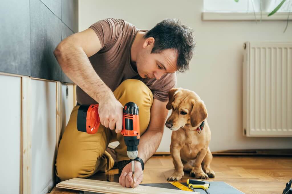 Man och hund som renoverar